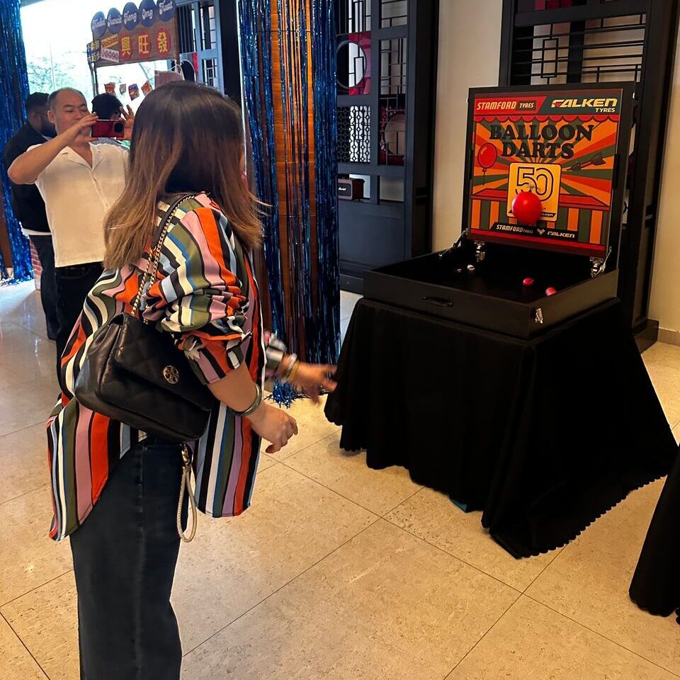 Carnival game booth rental in Malaysia for Stamford Tyres and Falken client event, creating fun engagement and interactive brand experiences.