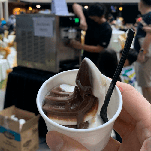 Soft serve ice cream rental machine serving creamy vanilla ice cream at an event.