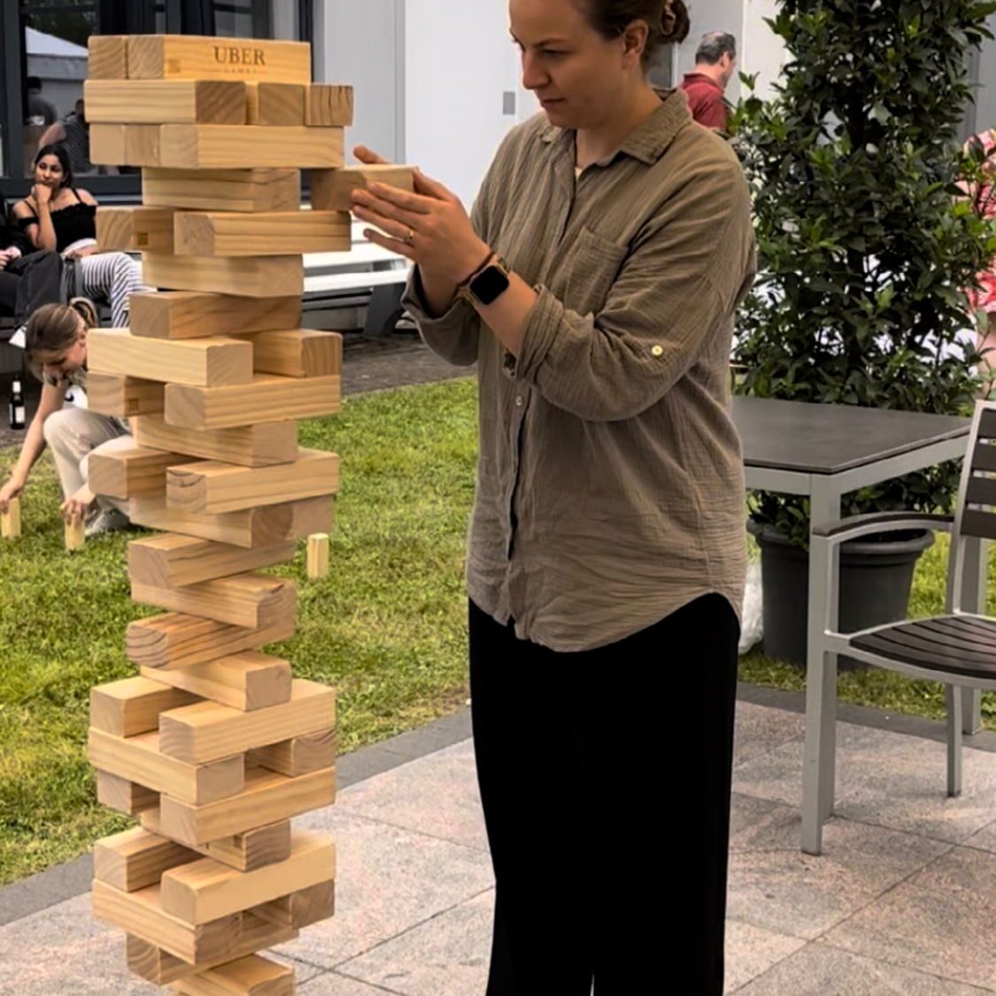Wedding guests playing Giant Jenga rental game during reception